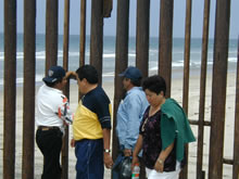 Four workers waiting by a fence